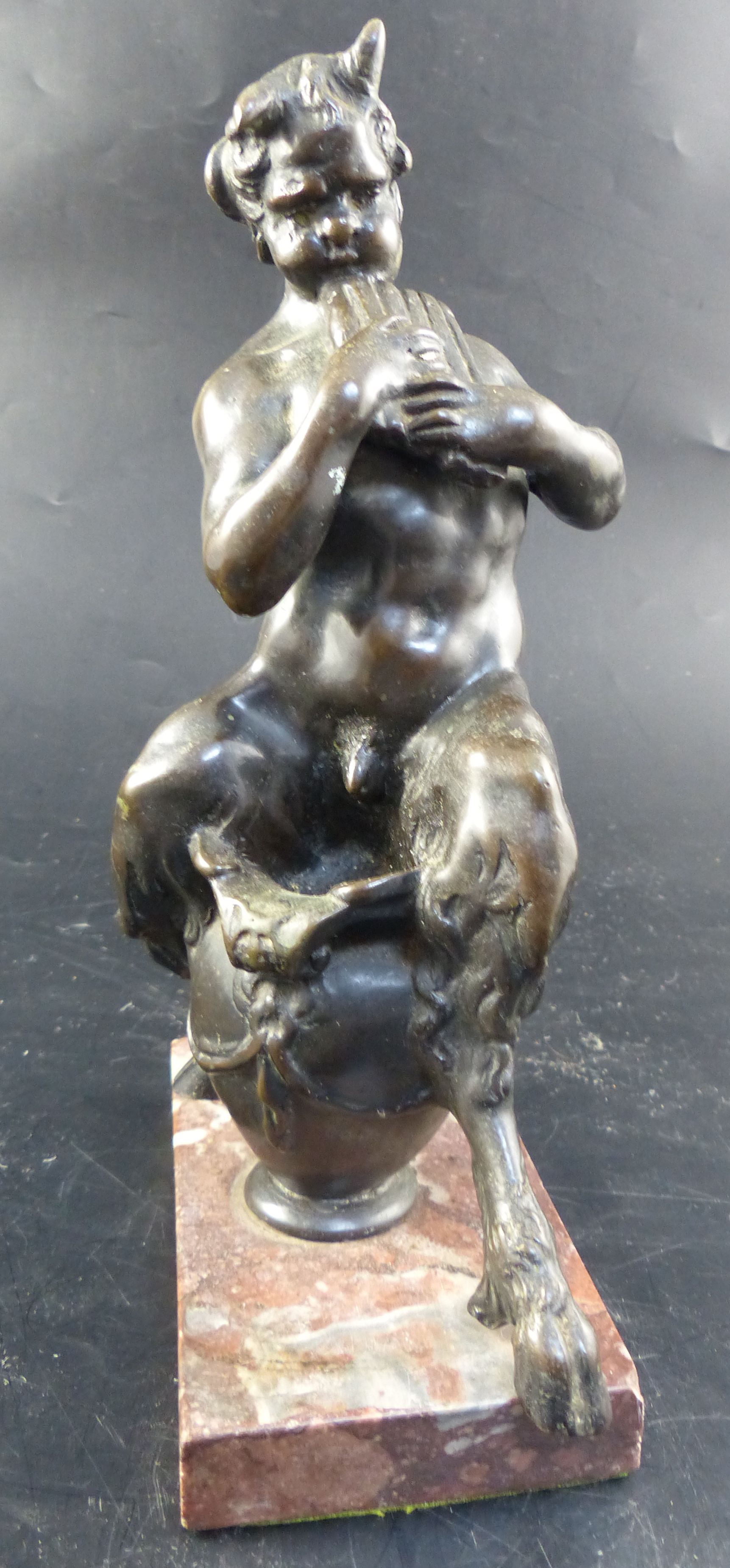 After Frederick Pomeroy (1856-1924). A 19th century Italian bronze model of a satyr playing pan pipes, overall height 24.5cm.